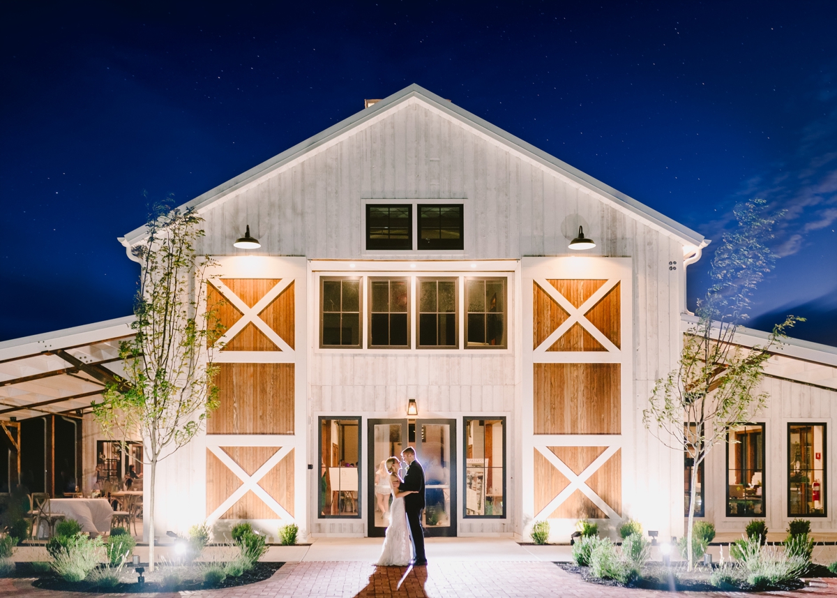 Bride and groom standing outside The Farmstead at Kent Island Resort