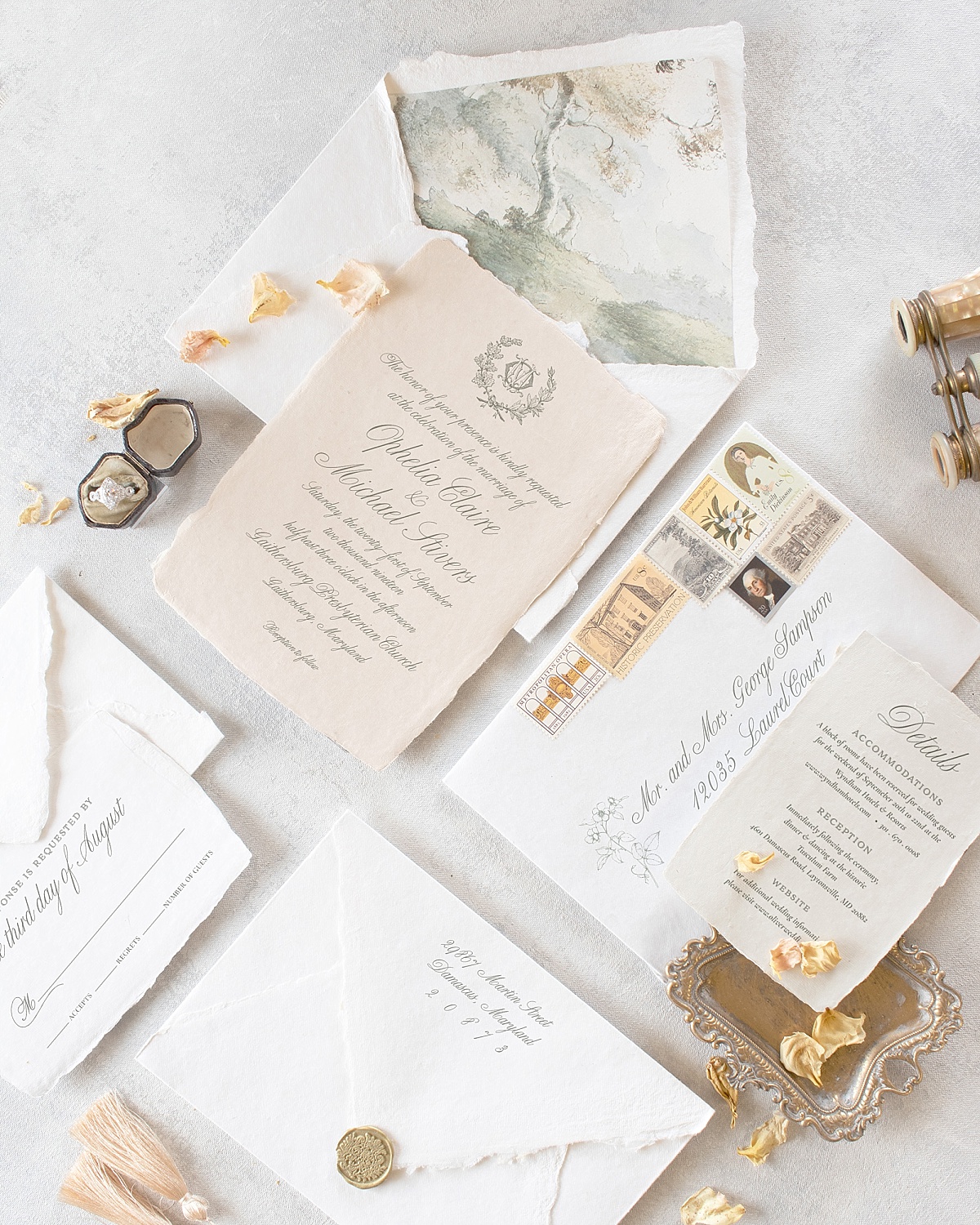 Flatlay of wedding invitations with artistic envelope liners 