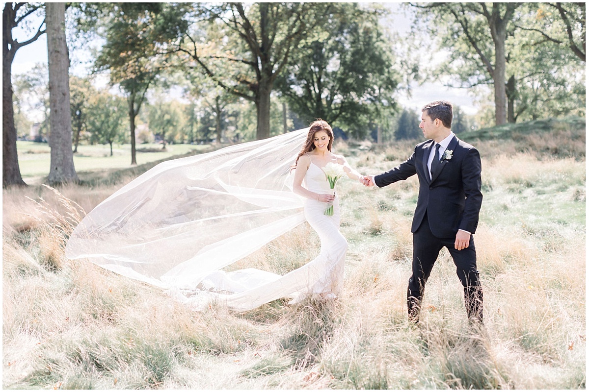 A wide shot of a bride and groom on the grounds of the Upper Montclair Country Club in Clifton, NJ 