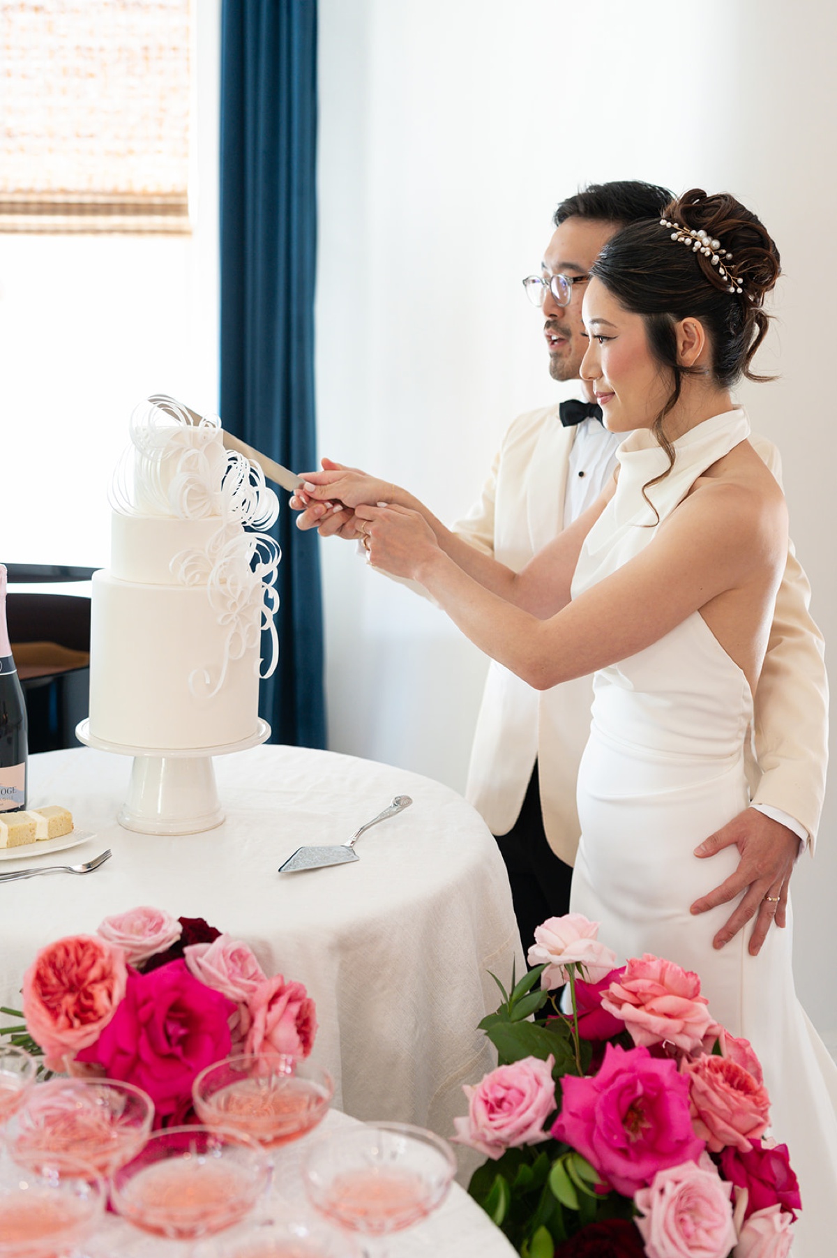 Bride and groom cutting into their wedding cake at Swann House